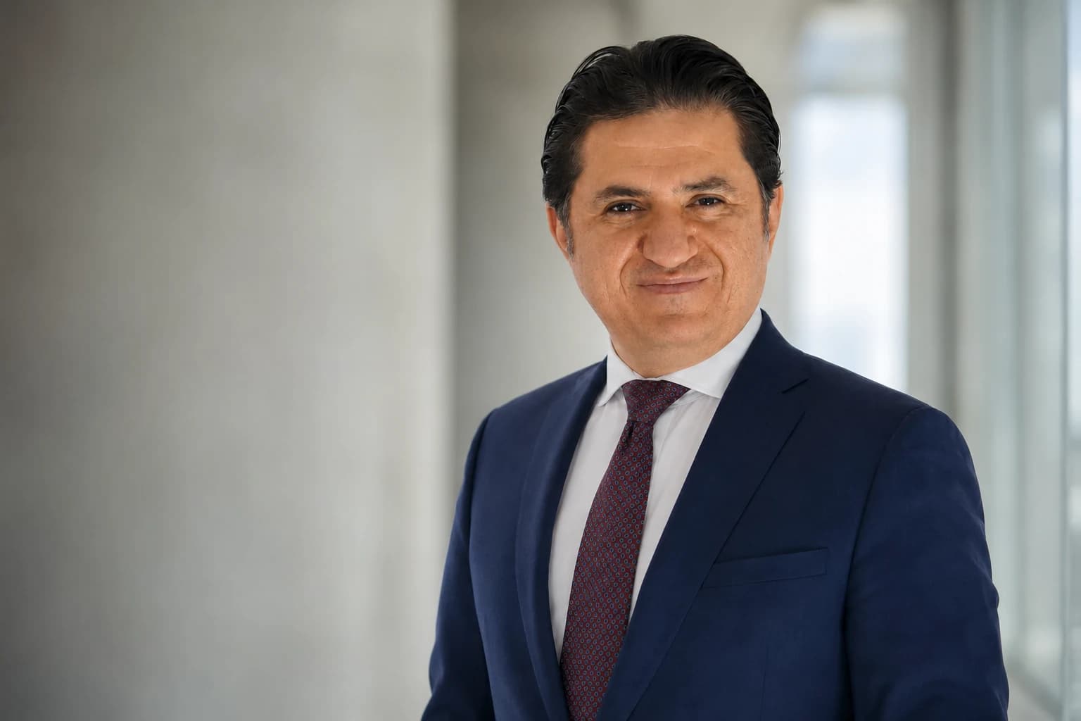 Portrait of Ali Emre Akgüneş in an executive setting.